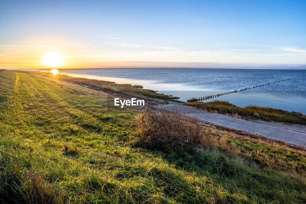 Scenic view of sea against sky during sunset