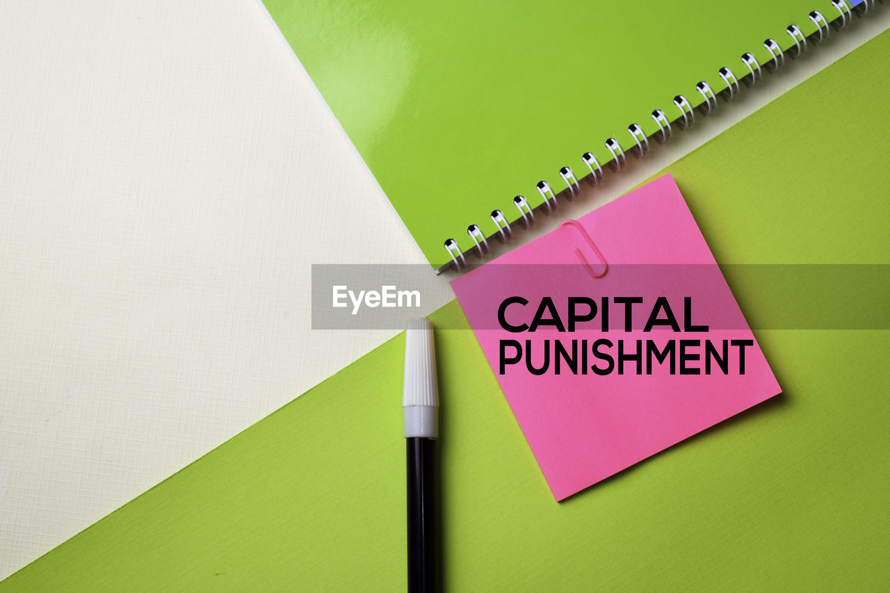Capital punishment text on adhesive note