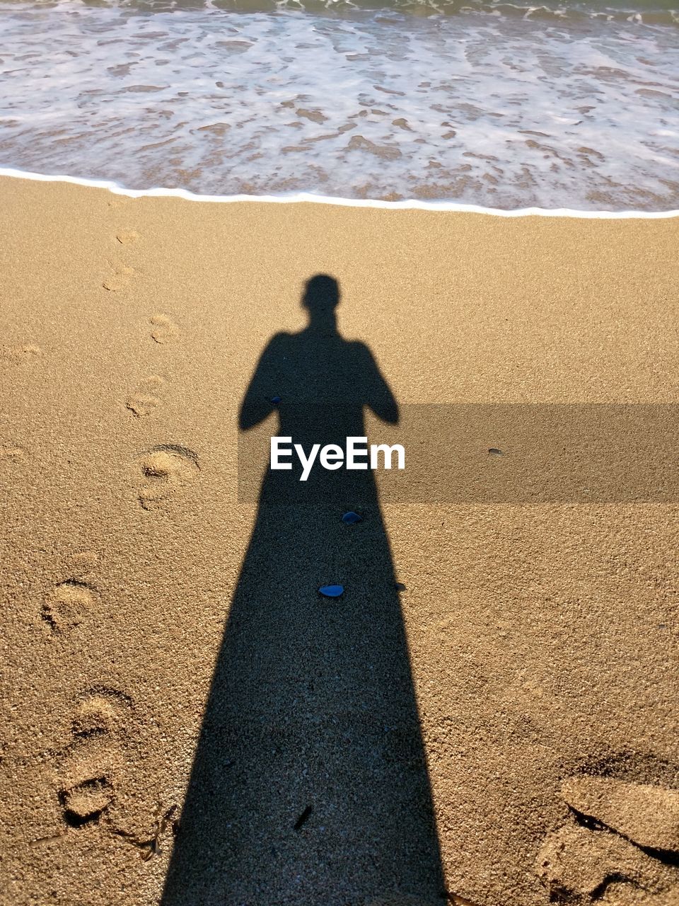 Shadow of person on beach