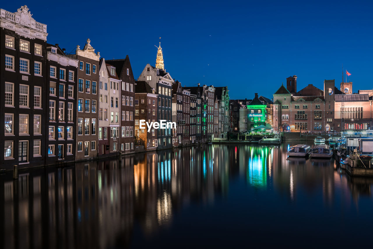 Illuminated buildings against sky