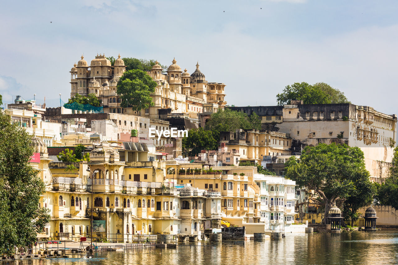 Buildings by lake in city