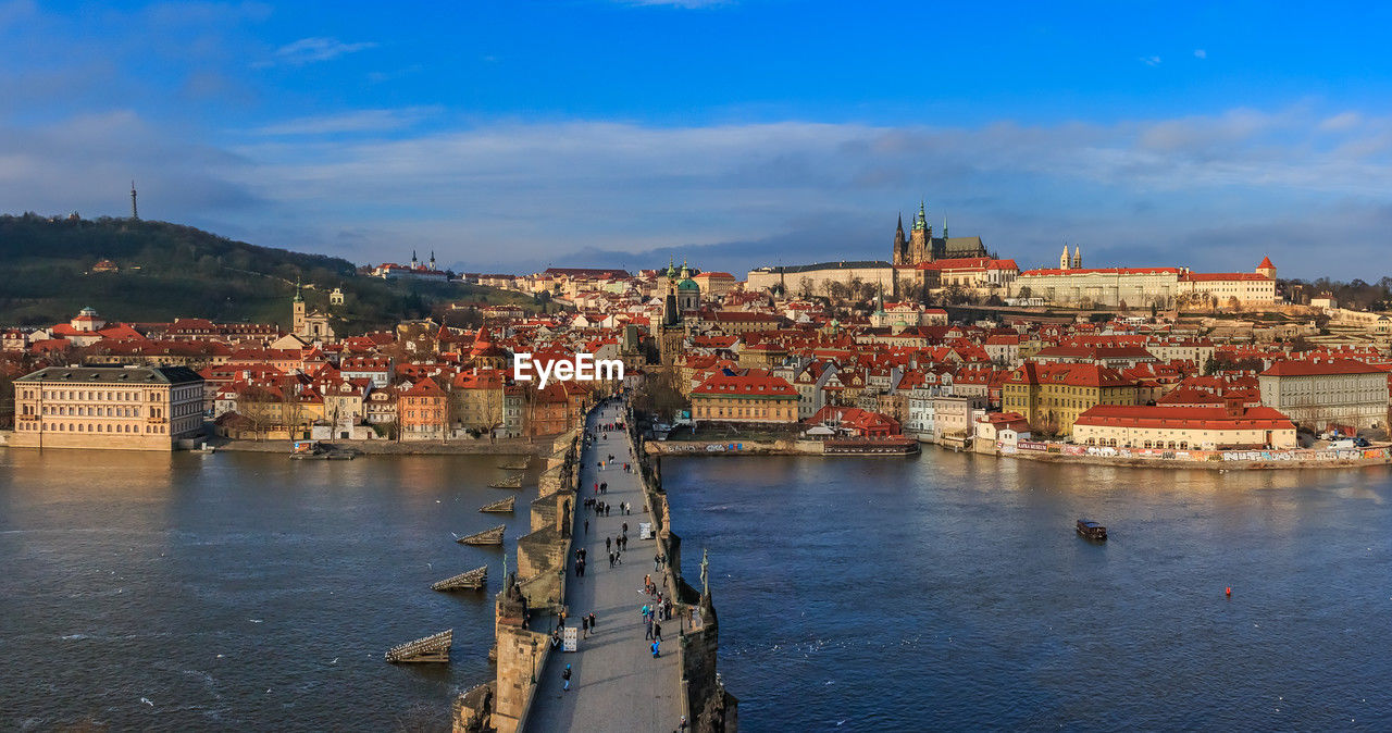 high angle view of townscape by river against sky