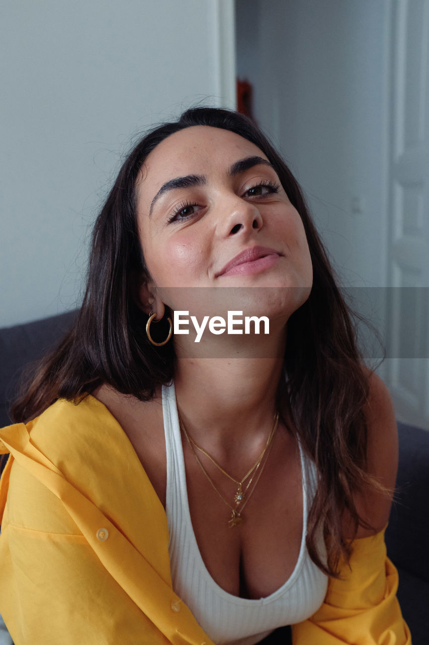 Portrait of beautiful woman sitting at home