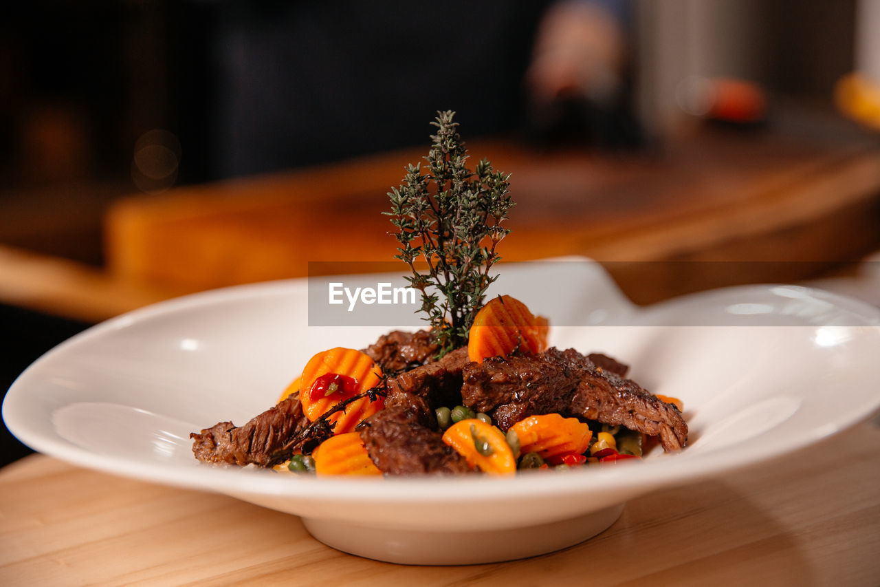 Beef meal presentation on white plate. chef specialty dish.