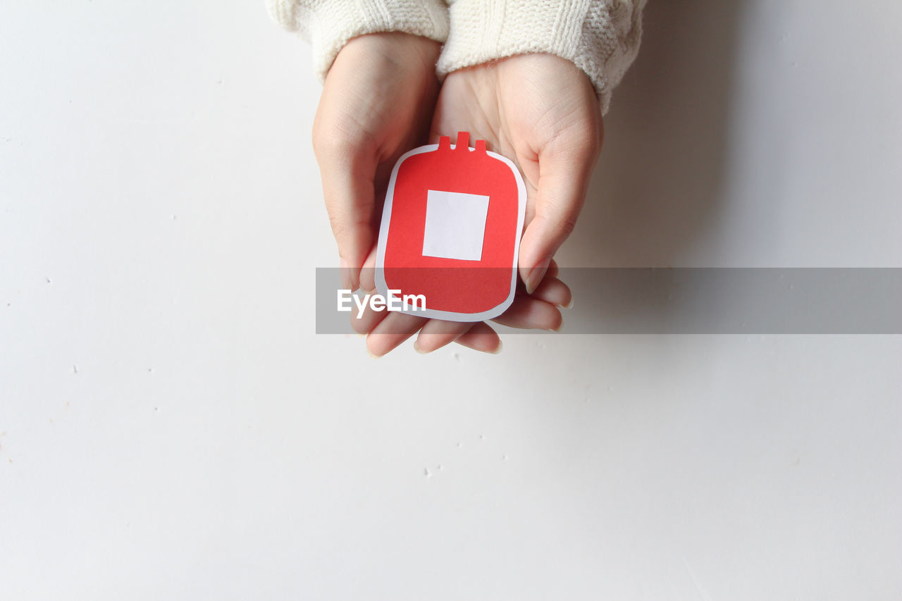 hand, one person, indoors, copy space, finger, holding, adult, studio shot, red, women, communication, white background