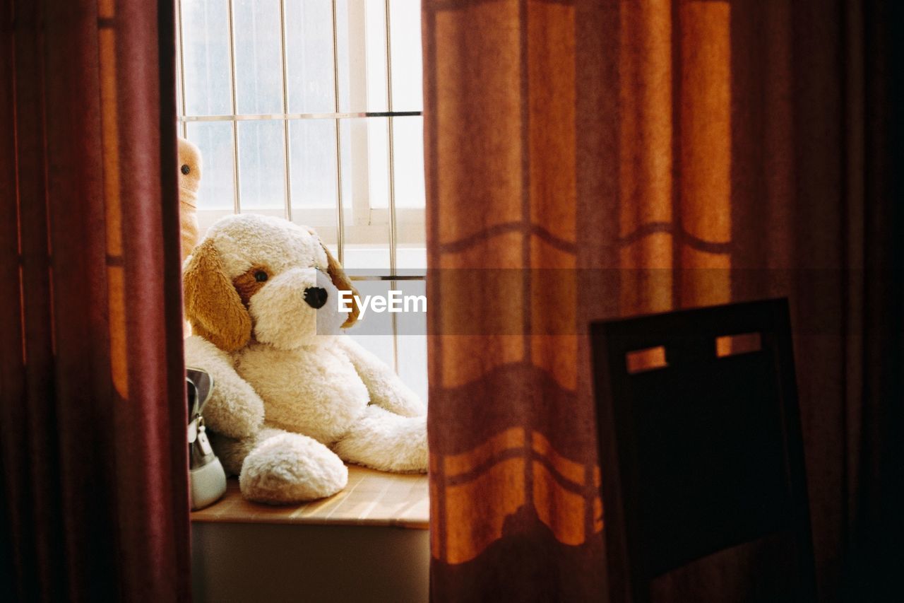 Close-up of stuffed toy on window sill