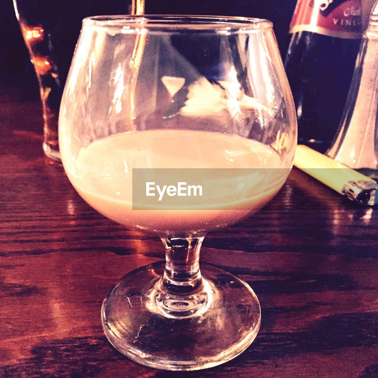 CLOSE-UP OF BEER GLASS ON TABLE