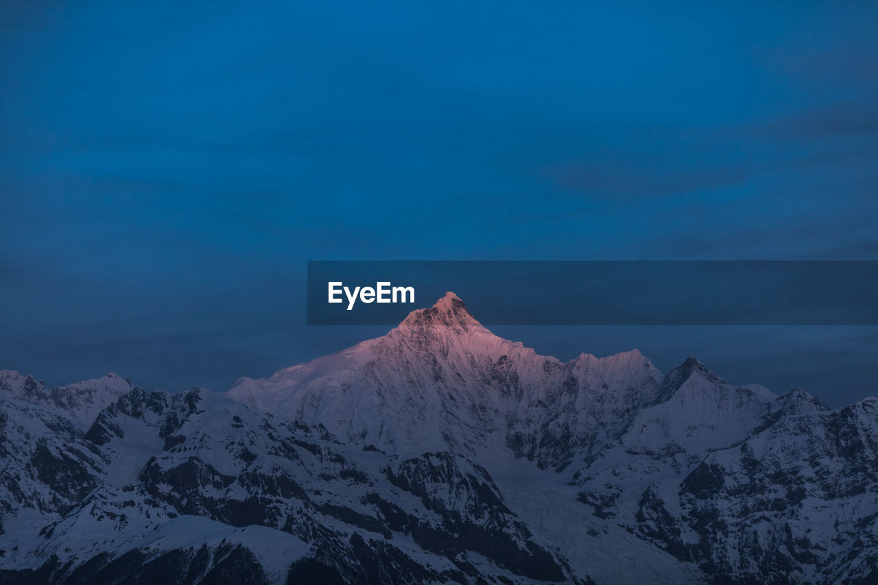 scenic view of snowcapped mountains against clear blue sky