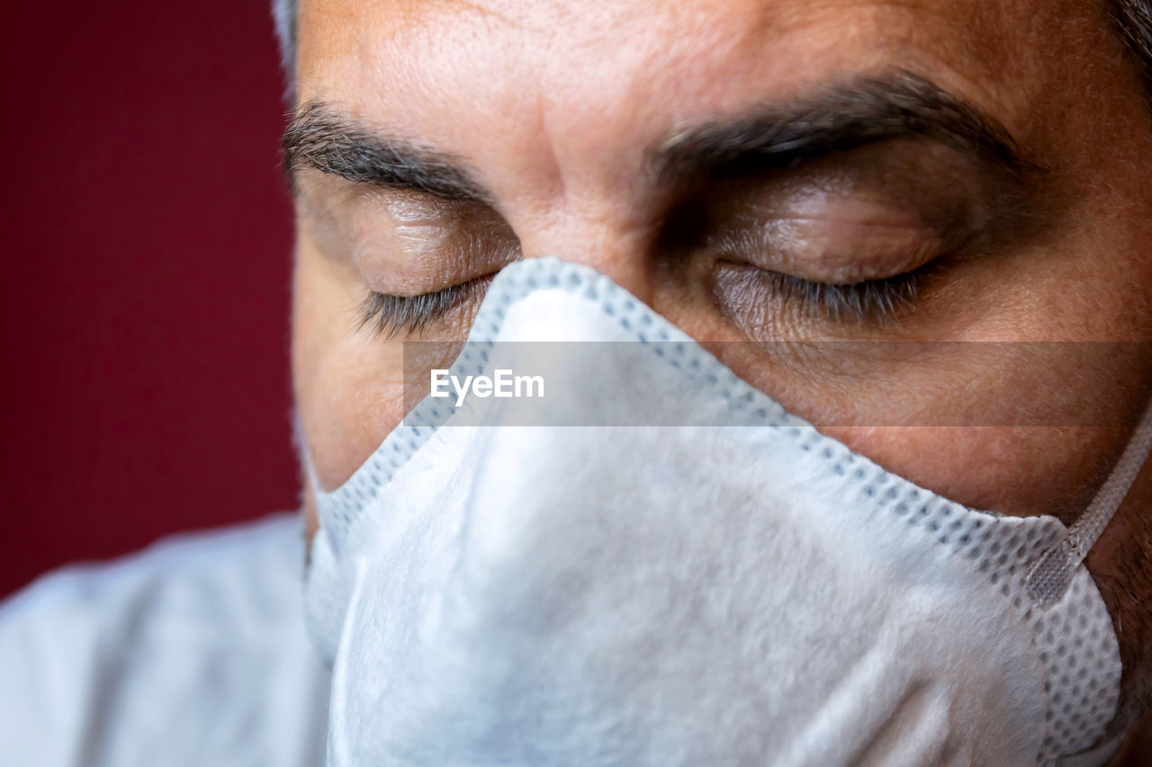 Close-up portrait of man covering face