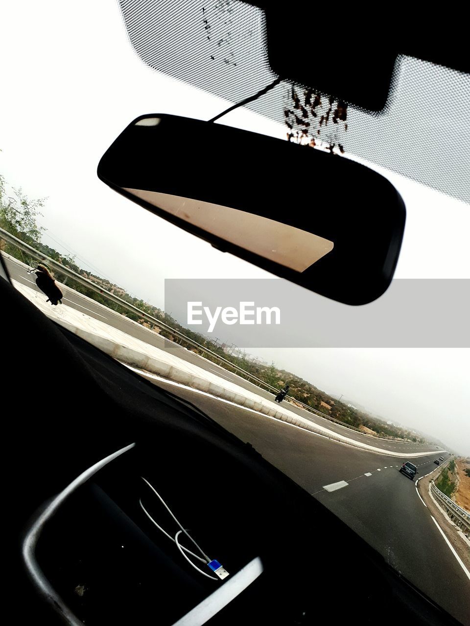 CLOSE-UP OF CAR WINDSHIELD WITH WINDOW