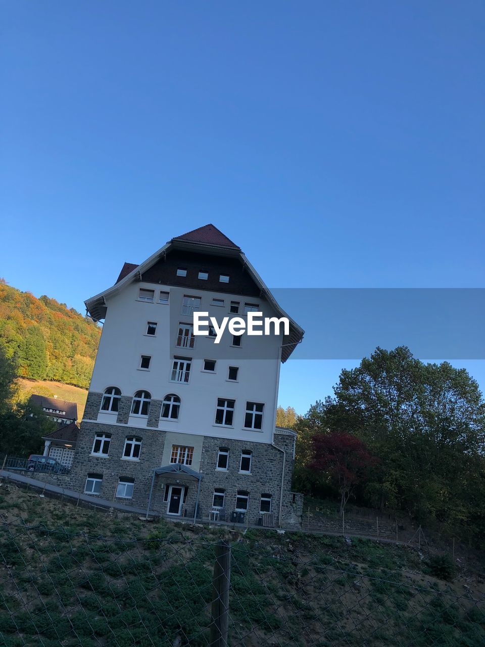 Low angle view of building against clear blue sky