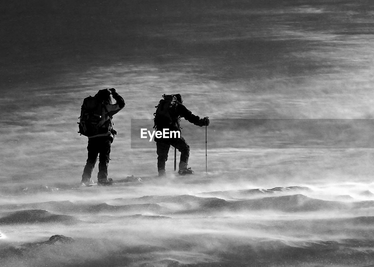 People walking on snow covered land