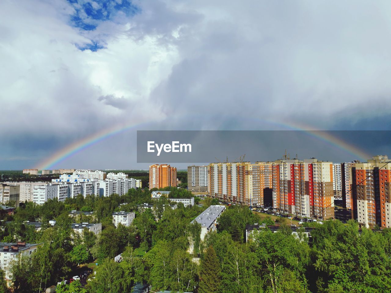 Panoramic view of rainbow over buildings in city