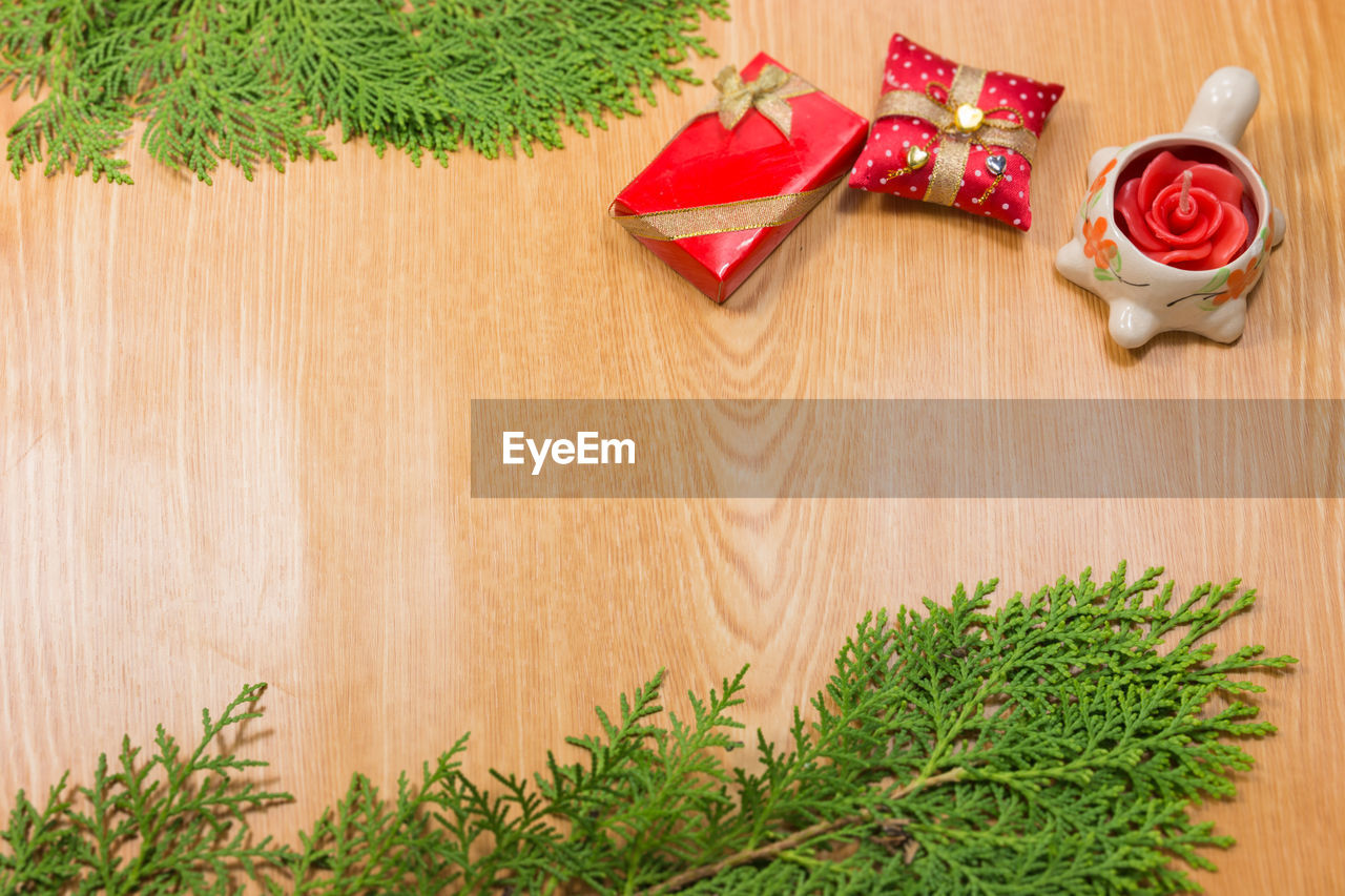 Close-up of pine tree with christmas decorations on wooden table