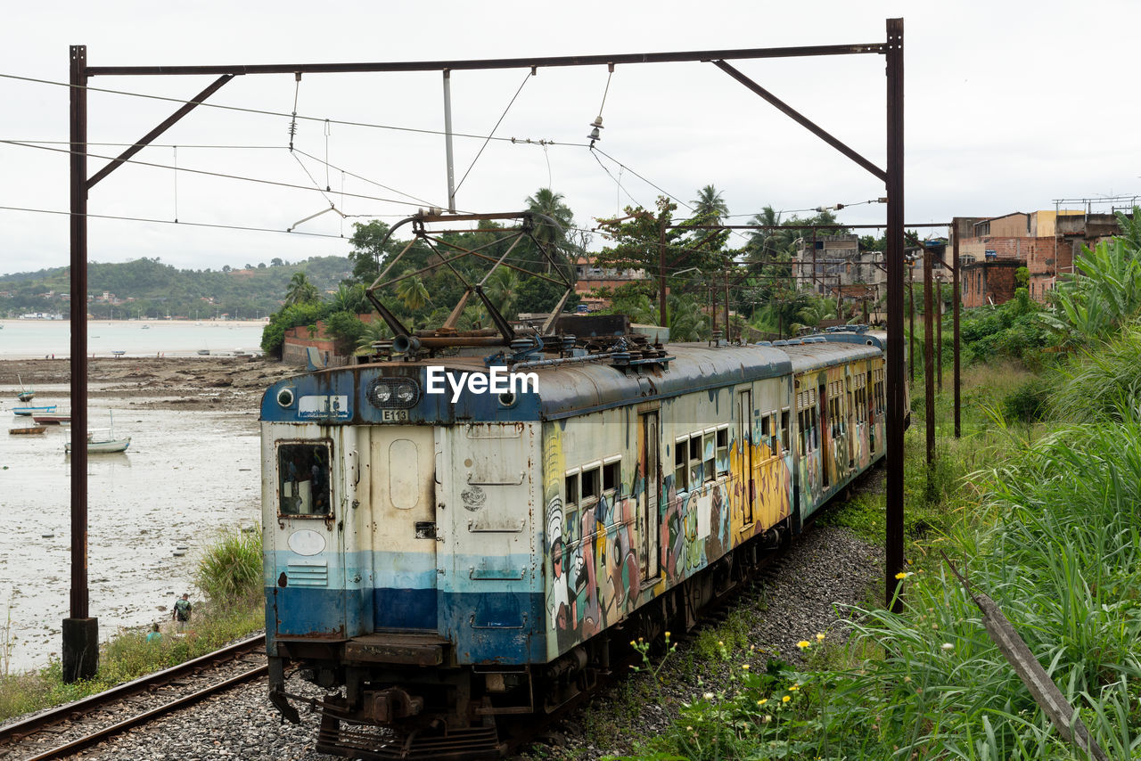 transportation, transport, mode of transportation, rail transportation, vehicle, track, railroad track, rolling stock, train, locomotive, railway, nature, railroad car, land vehicle, sky, public transportation, travel, plant, day, no people, architecture, water, outdoors, electricity