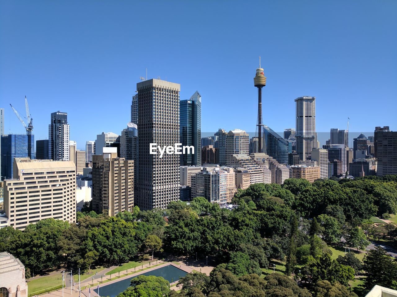 Low angle view of skyscrapers against blue sky