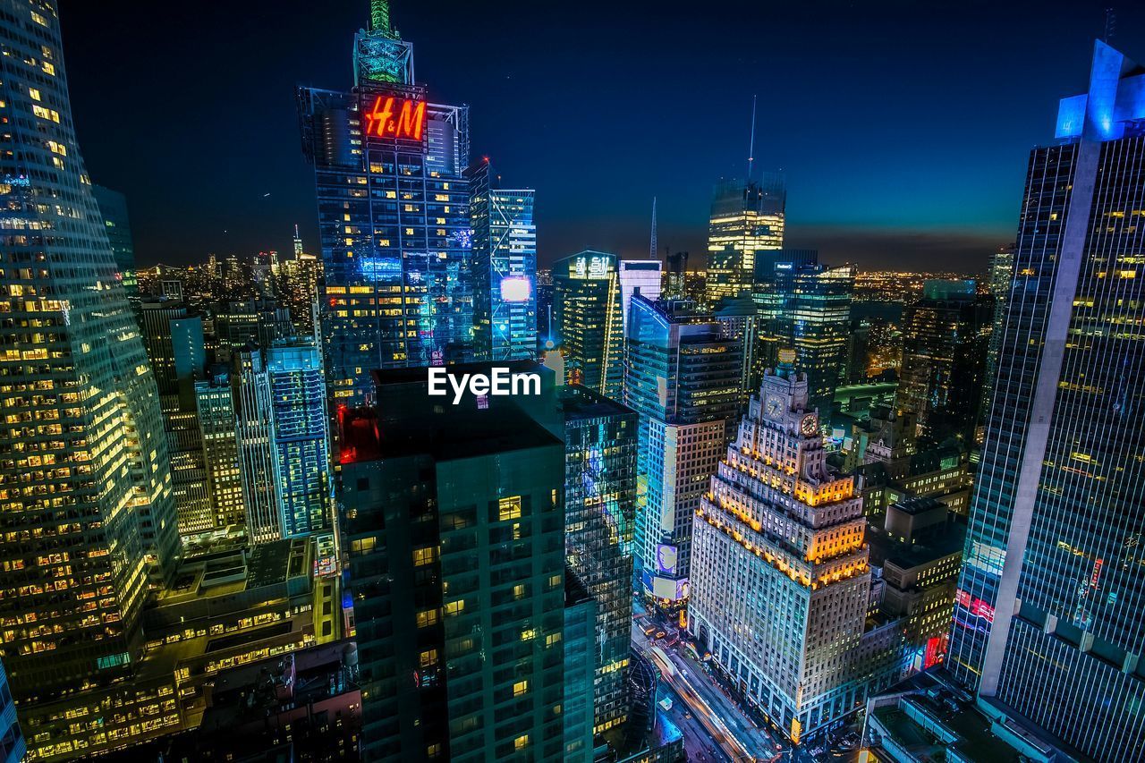 Illuminated manhattan against sky at night