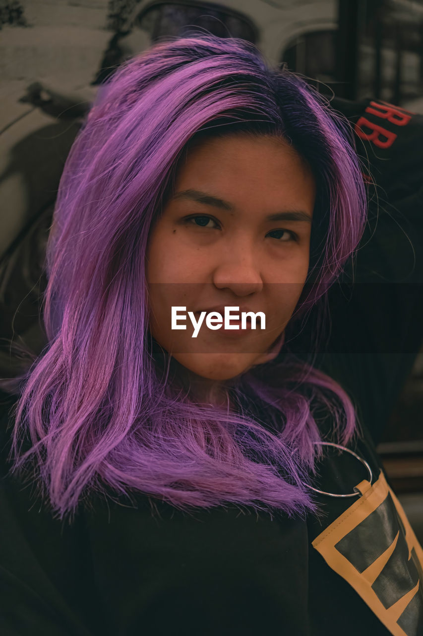 Purple hair asian woman expression
