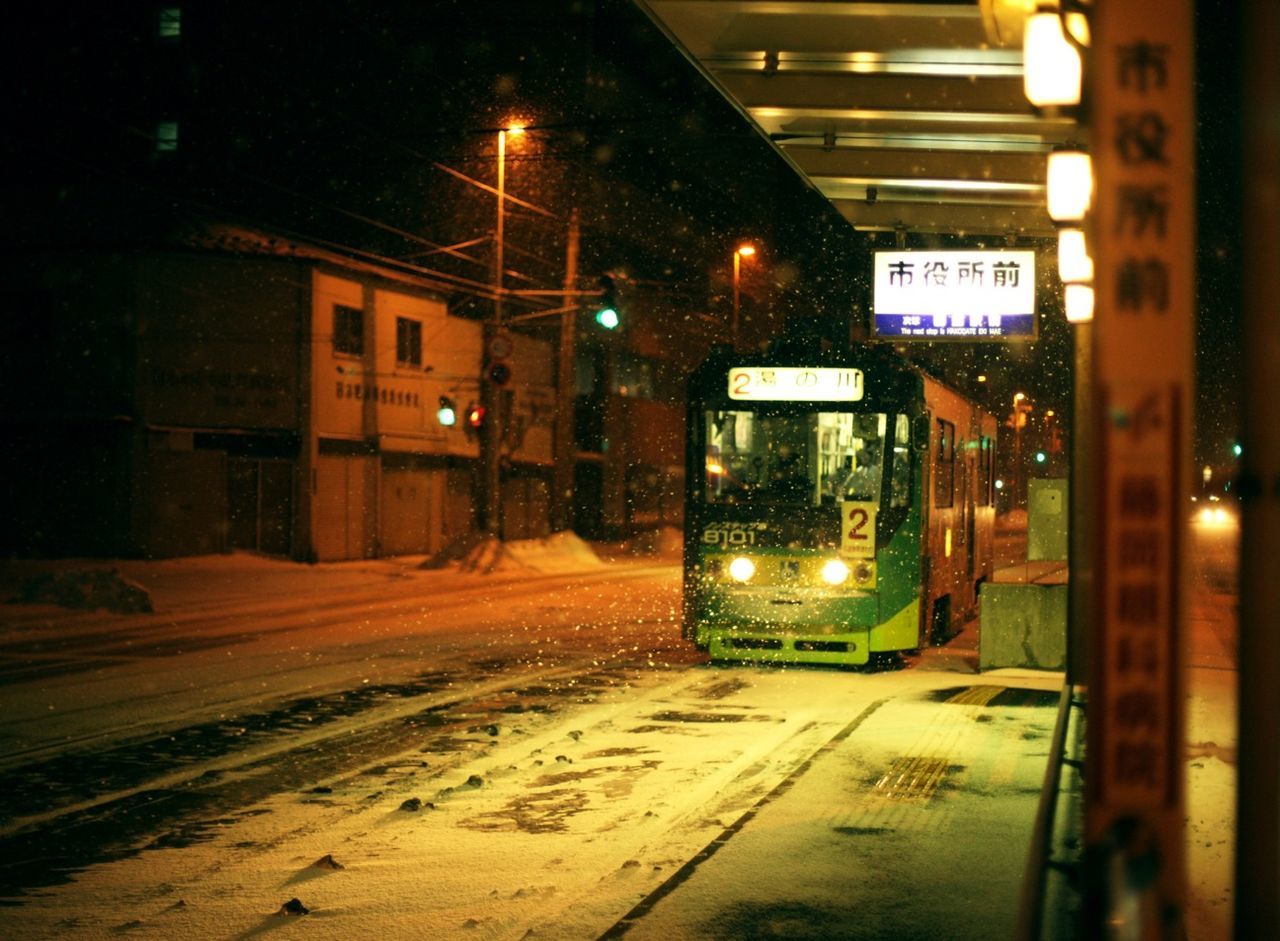 VIEW OF ILLUMINATED CITY AT NIGHT