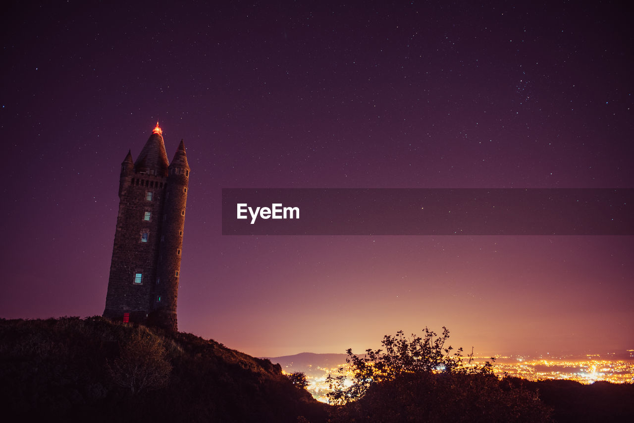 Low angle view of scrabo tower against sky at night