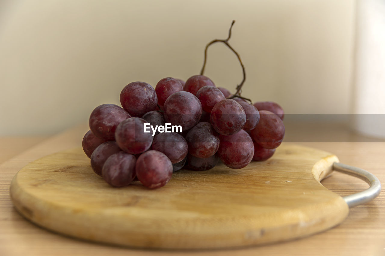 Close-up of grapes in container on table