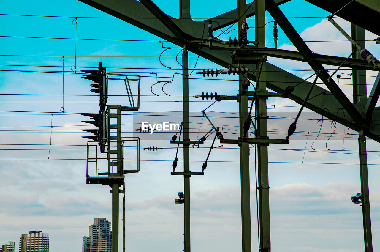 Low angle view of electricity pylon against sky