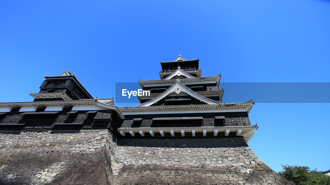 Low angle view of japanese castle against clear sky