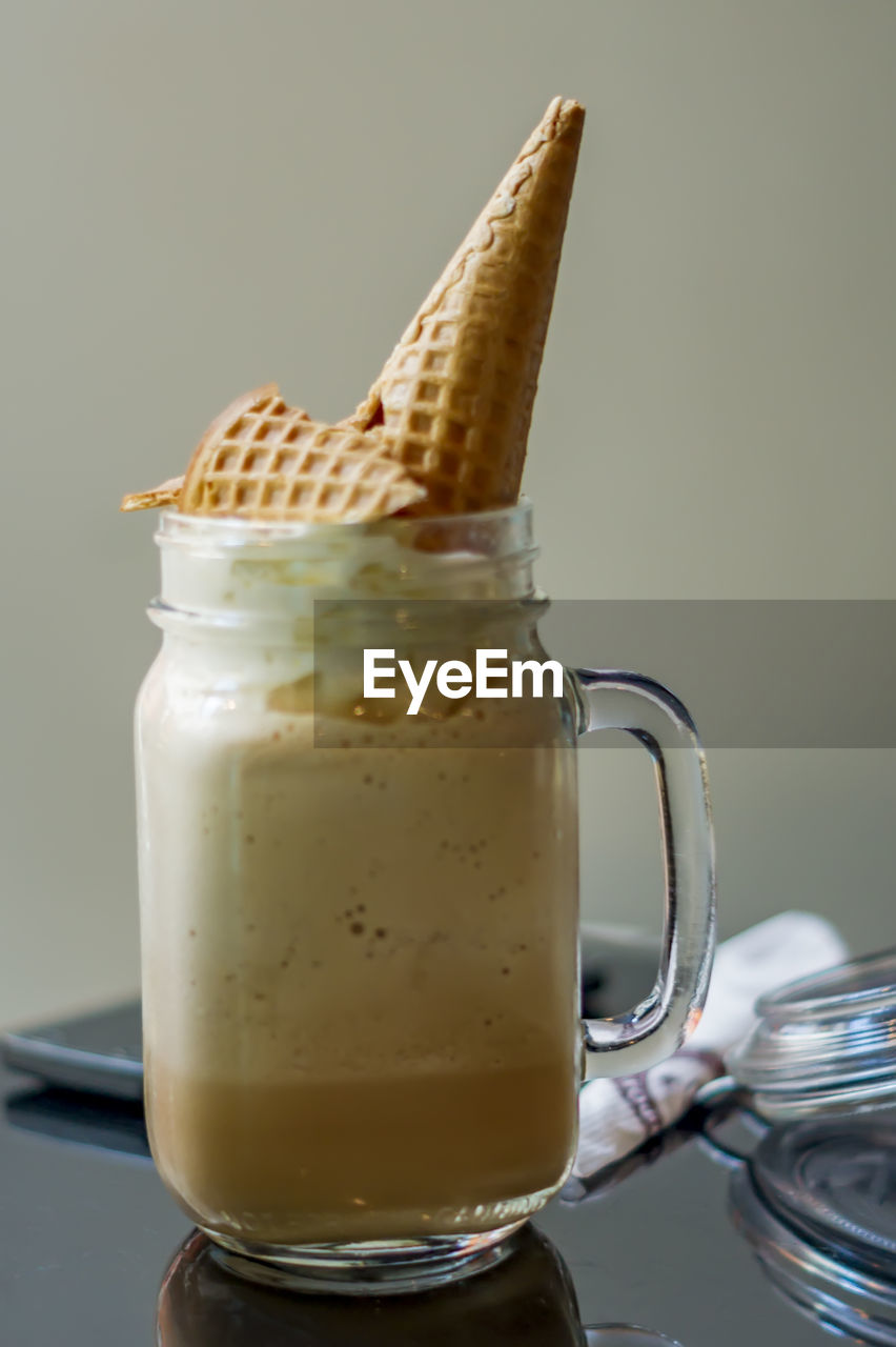 Cold coffee with whipped cream and waffle cone