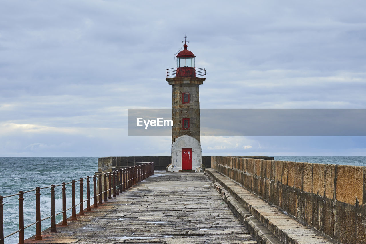 LIGHTHOUSE AT SEA AGAINST SKY