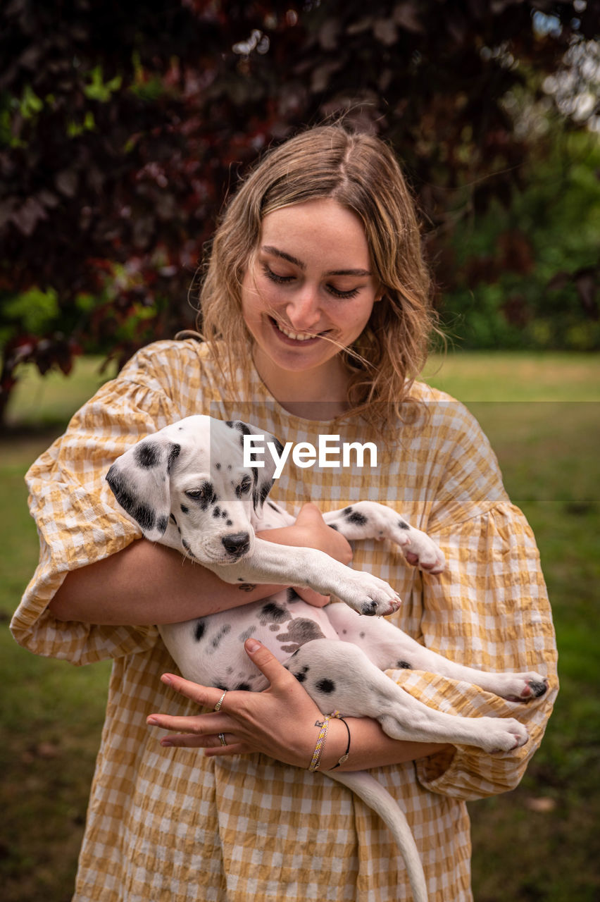 Young woman with a dalmatian puppy