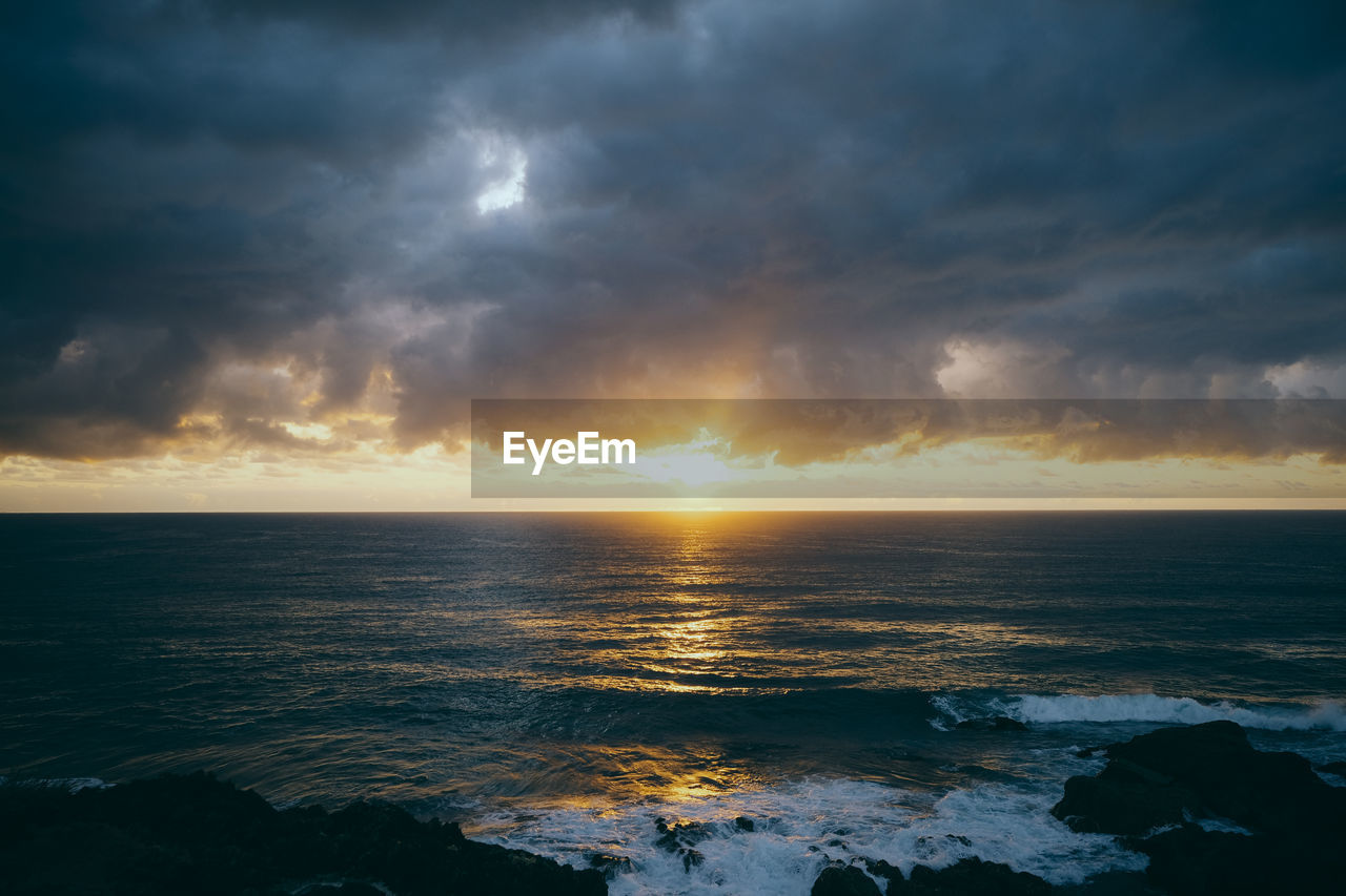 scenic view of sea against sky at sunset