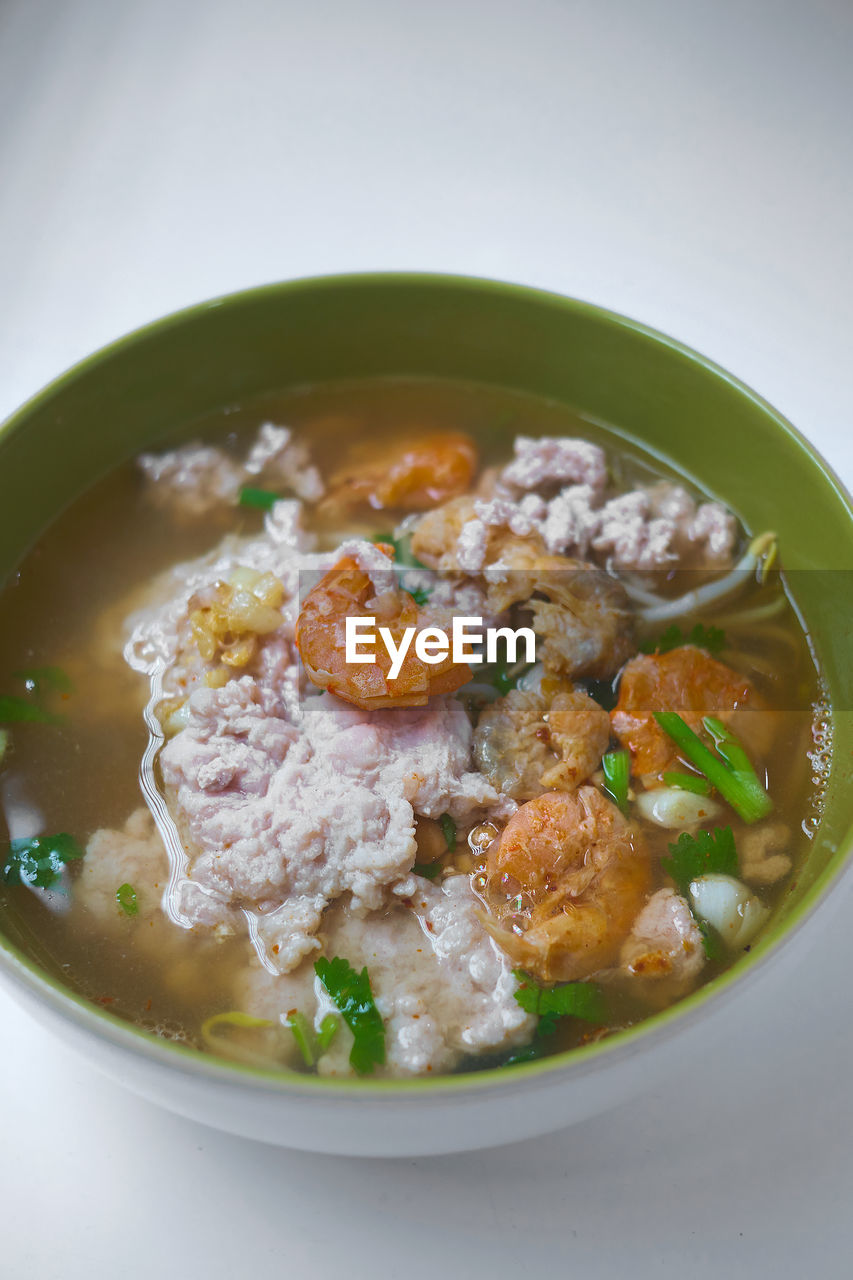 CLOSE-UP OF SOUP SERVED ON TABLE