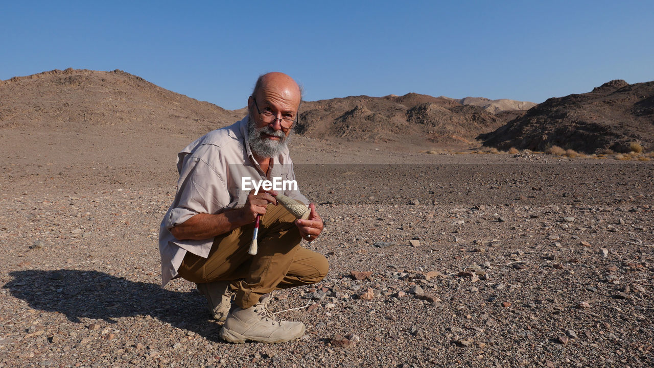 Archaeologist at work in the desert 