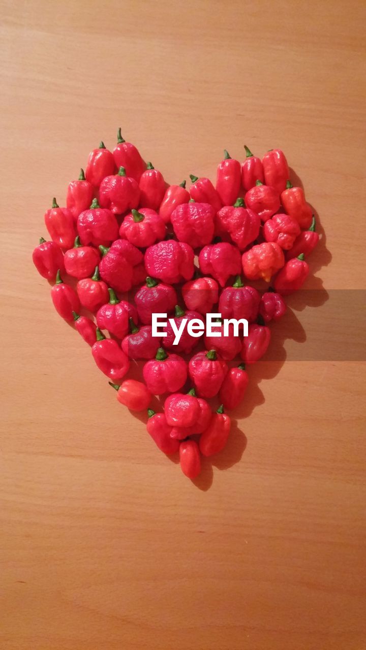 CLOSE-UP OF RASPBERRIES ON WOODEN TABLE