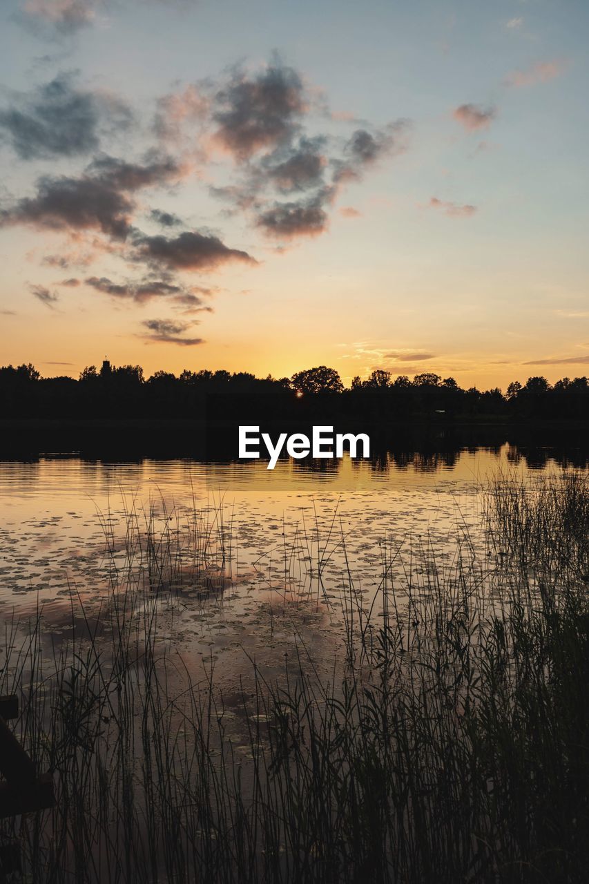 Scenic view of lake against sky during sunset