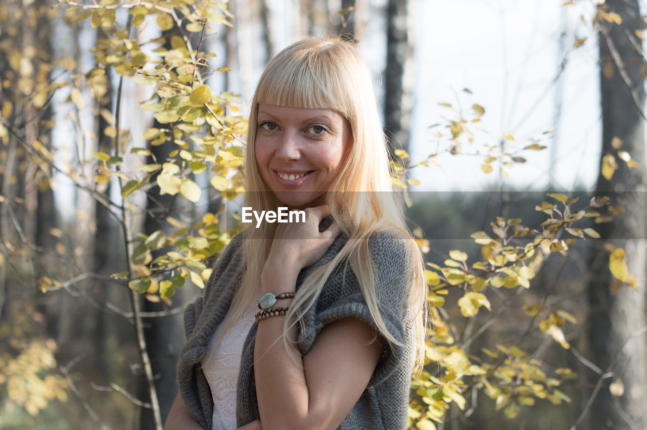 Portrait of smiling woman standing outdoors