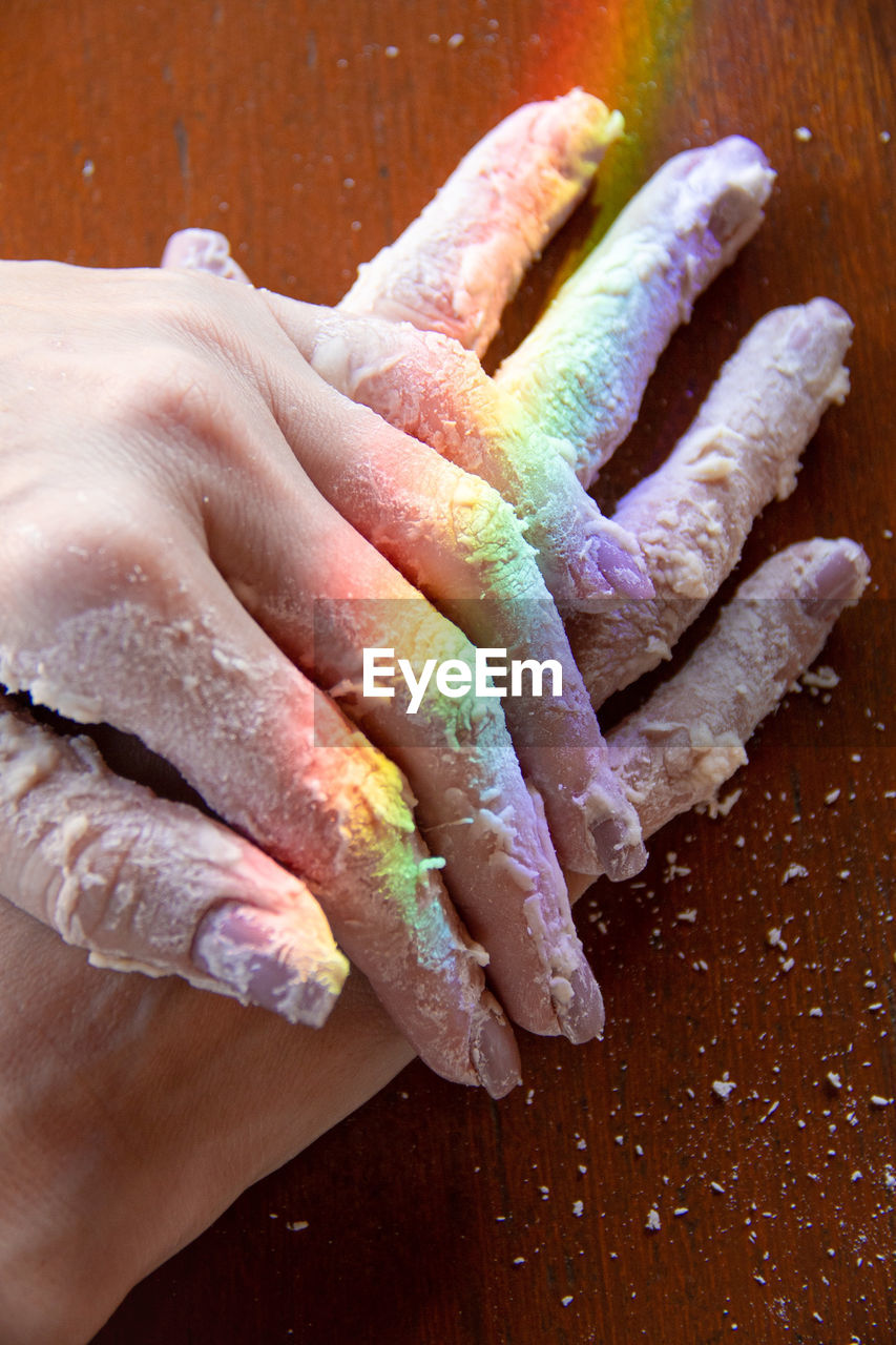 finger, hand, nail, one person, food and drink, food, indoors, icing, close-up, dessert, high angle view, adult, freshness, wood, baked