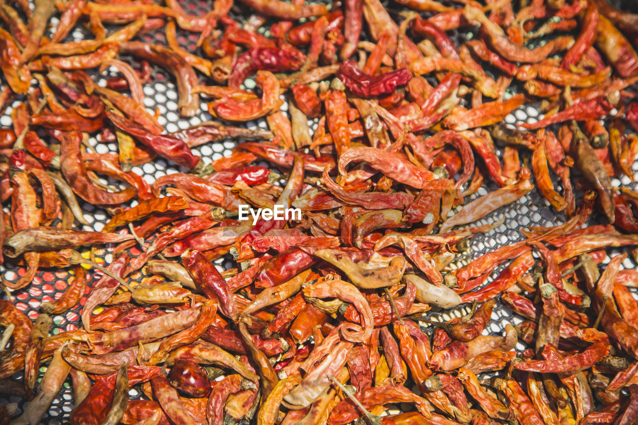 Full frame shot of red chili peppers on floor