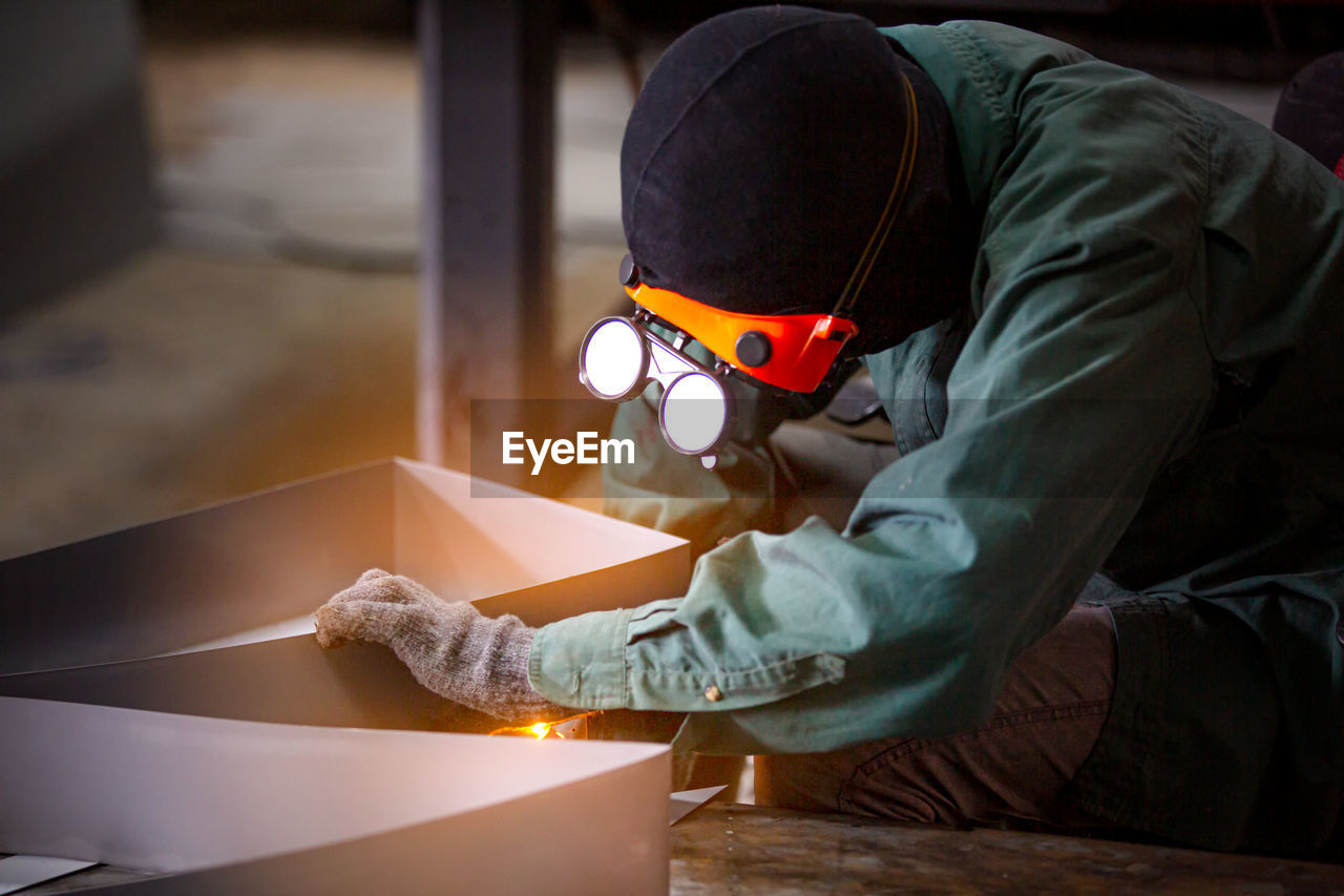 Workers are welding a steel frame.