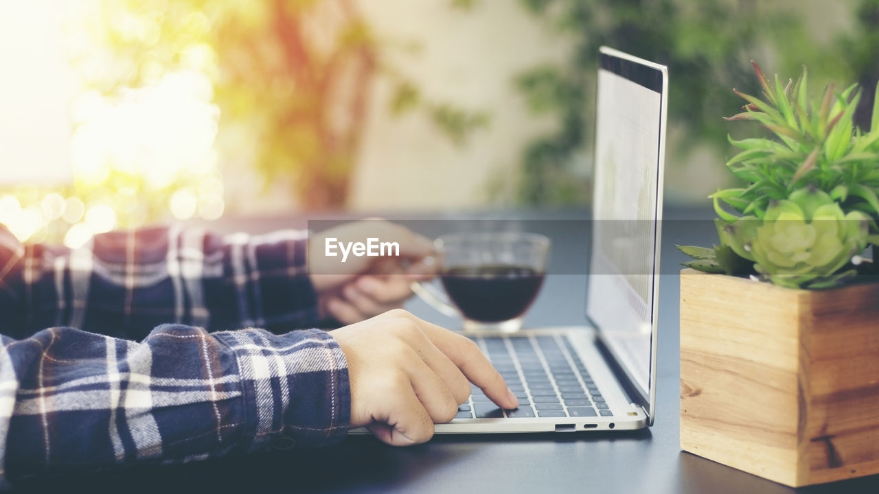 Businessman using laptop with drinking coffee ,work from home concept