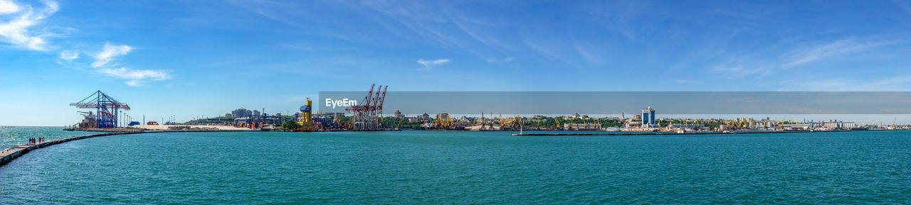 Lighthouse at the entrance to the harbor of odessa seaport, on a sunny summer day