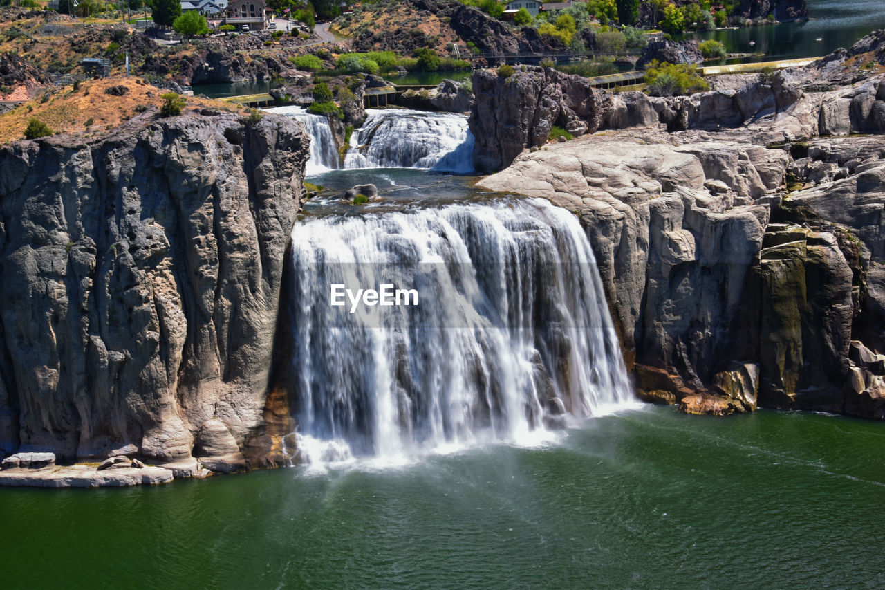 waterfall, water, scenics - nature, beauty in nature, rock, water feature, body of water, motion, nature, environment, land, rock formation, travel destinations, cliff, long exposure, no people, flowing water, sea, plant, tourism, travel, tree, outdoors, non-urban scene, water resources, landscape, watercourse, forest, day, idyllic, flowing, splashing, blurred motion, sports, power in nature