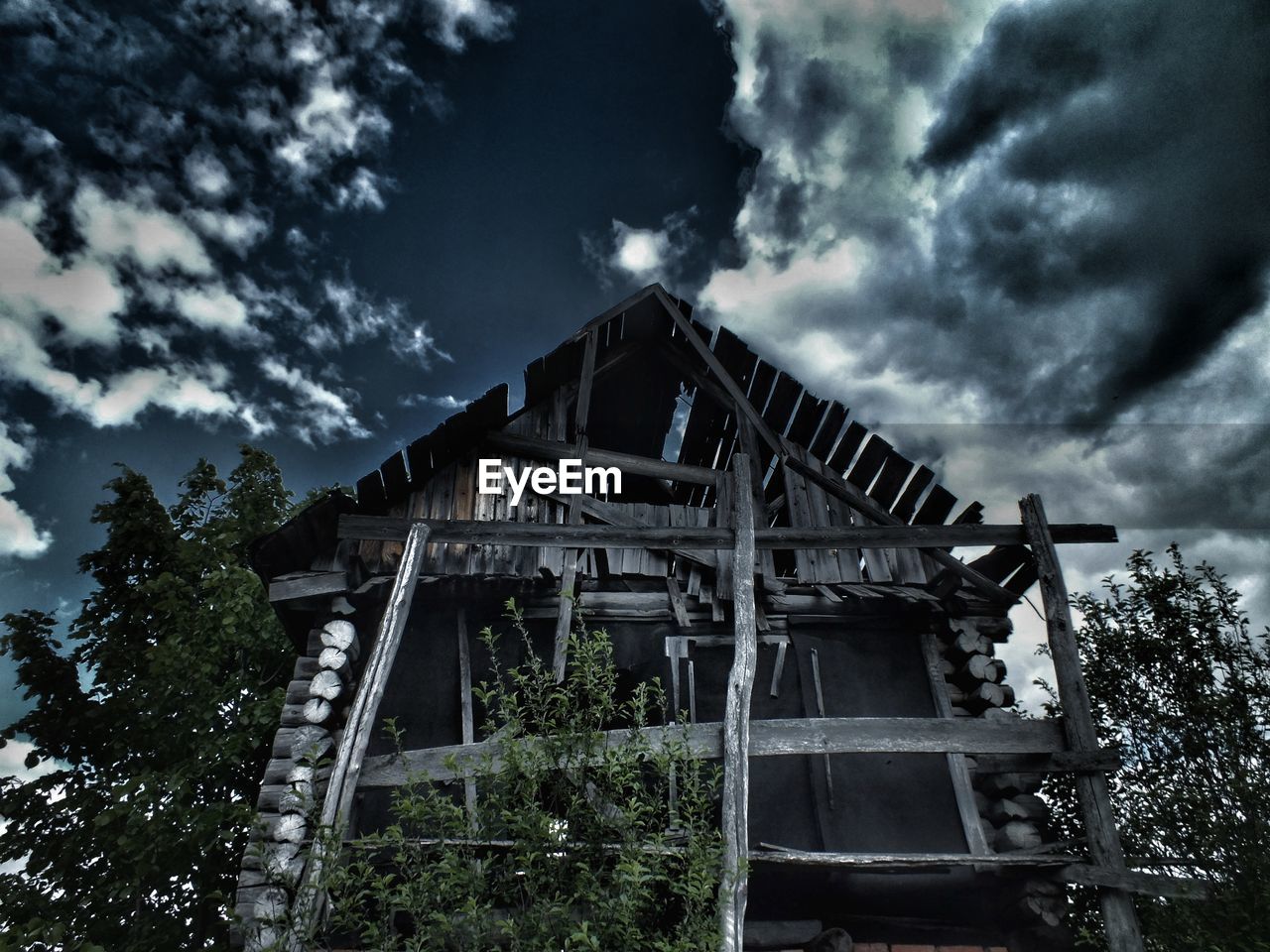 Low angle view of abandoned building against sky