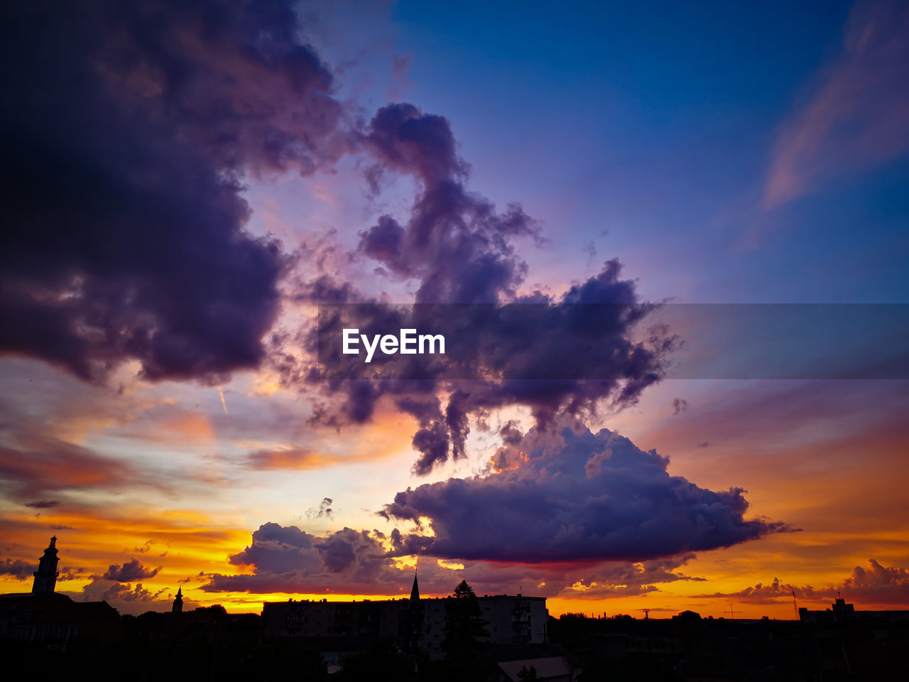 Low angle view of silhouette buildings against sky during sunset