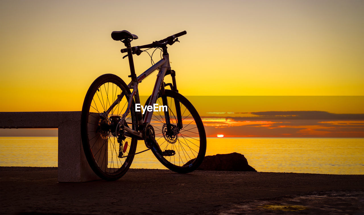 BICYCLE ON BEACH DURING SUNSET