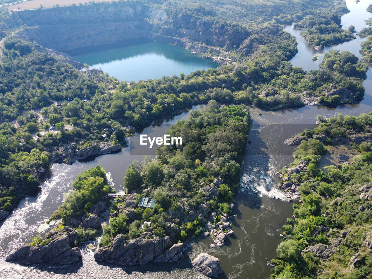 HIGH ANGLE VIEW OF RIVER FLOWING IN FOREST