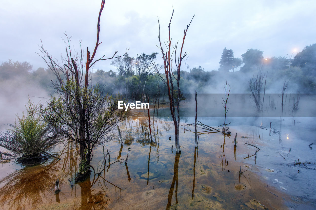 Scenic view of hot spring against sky