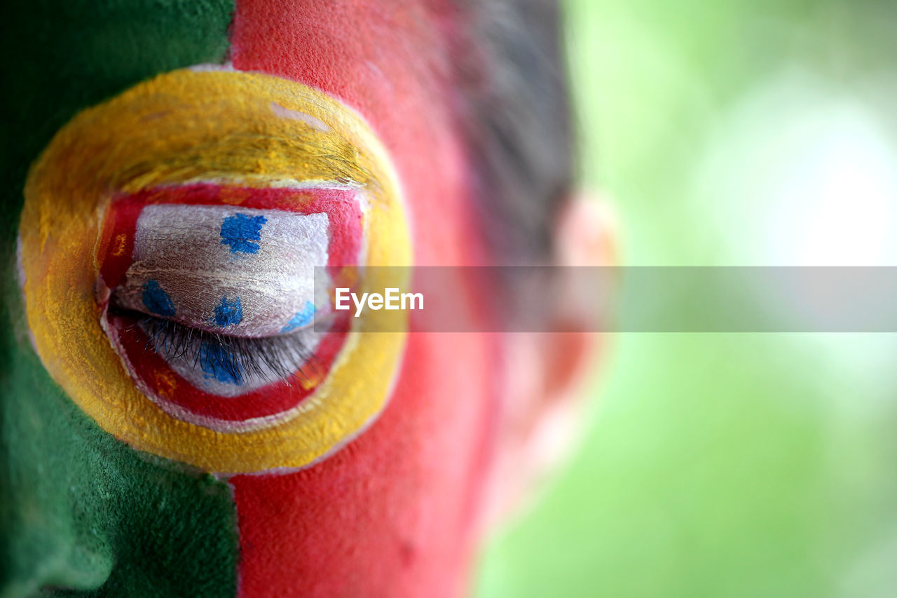 Close-up of soccer fan with portuguese flag painted on face