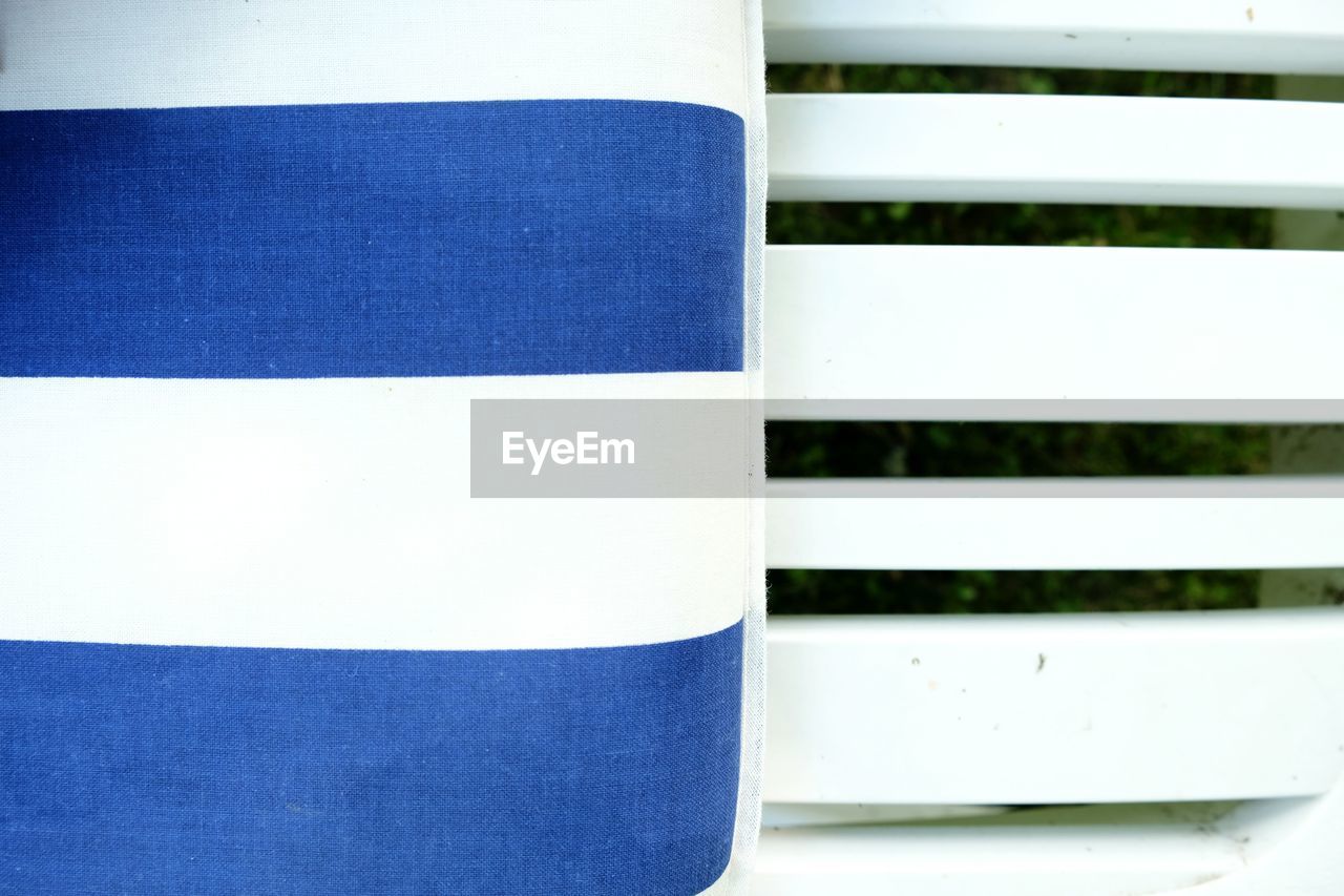 Cropped image of blue and white chair