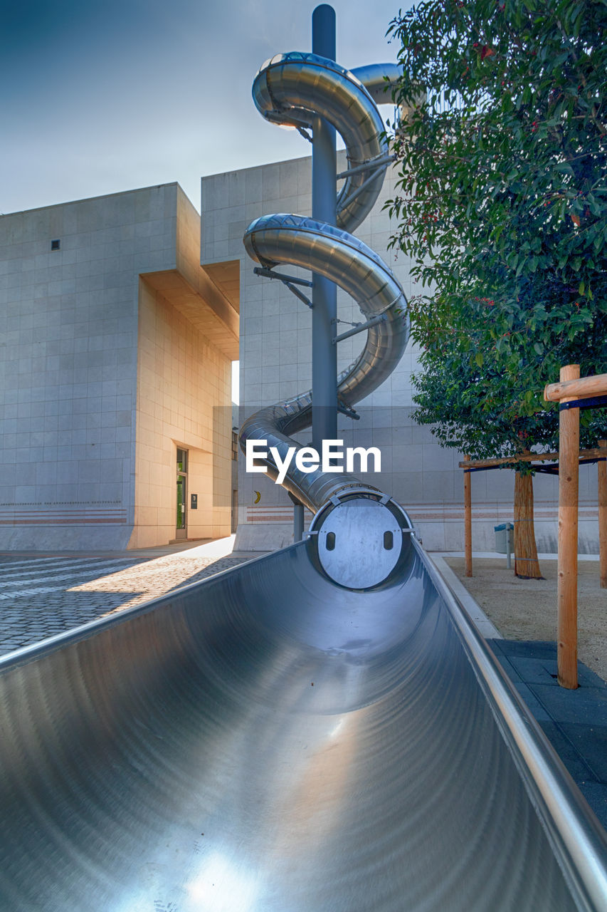 EMPTY PLAYGROUND AGAINST BUILDINGS